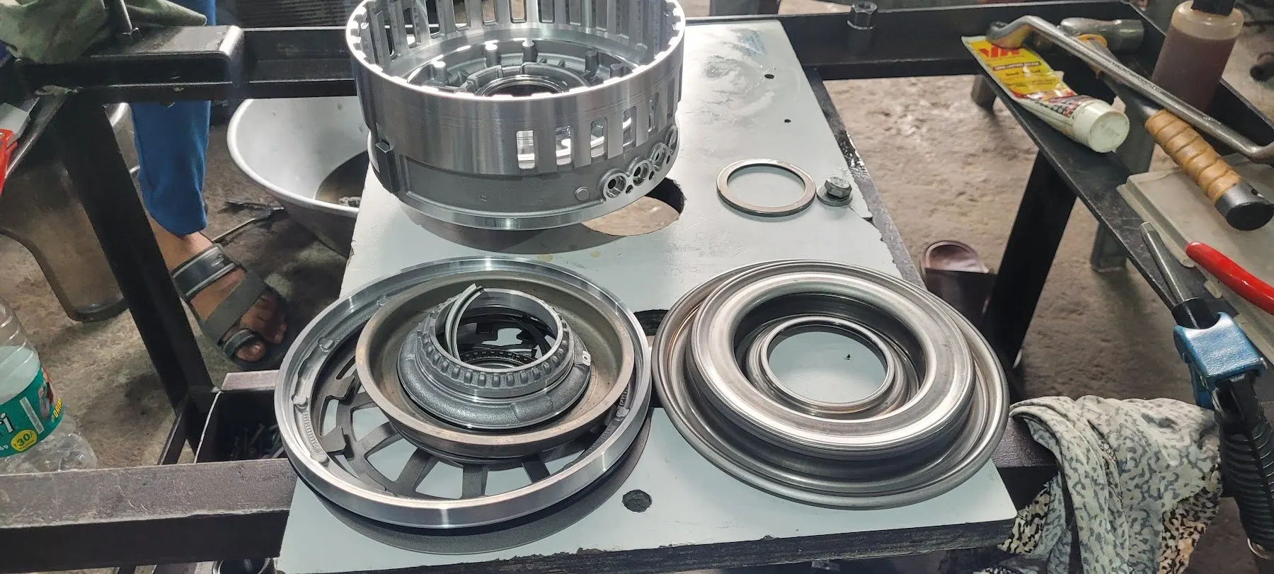 Clutch pistons and housings laid out on the rebuild bench